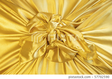 Gift box wrapped in golden crepe 57782590