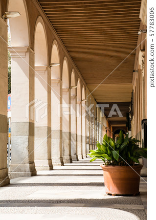 Corridor of buildings with pastel columns under strong sunlight (Majorca cityscape) 57783006