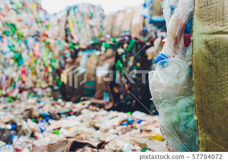 Plastic bales of tetra pak juice packages at waste processing plant. Concept of separate garbage Plastic bales of tetra pak juice packages at waste processing plant. Concept of separate garbage 57784072