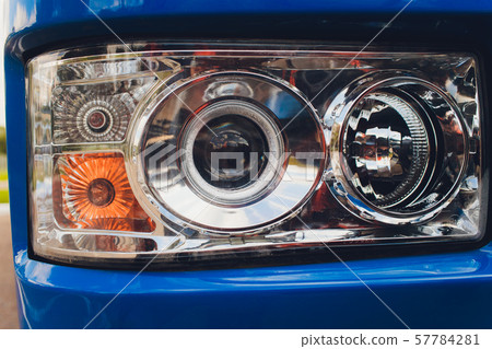 closeup photo of spotlight and wheels of tractor. closeup photo of spotlight and wheels of tractor. 57784281