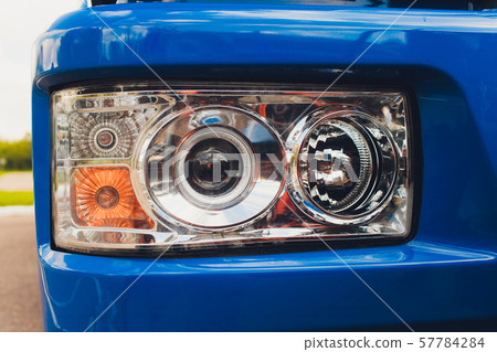 closeup photo of spotlight and wheels of tractor. closeup photo of spotlight and wheels of tractor. 57784284