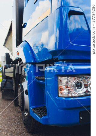 closeup photo of spotlight and wheels of tractor. 57784286