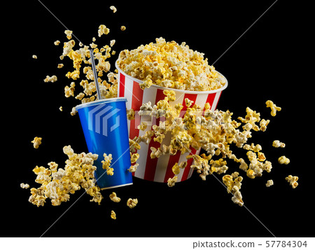Set of paper striped bucket with popcorn and cup of soft drink isolated on black Set of paper striped bucket with popcorn and cup of soft drink isolated on black 57784304