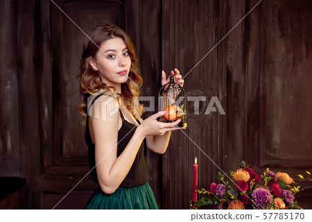 Holidays, halloween, decoration and people concept - close-up of woman with pumpkins at home Holidays, halloween, decoration and people concept - close-up of woman with pumpkins at home 57785170