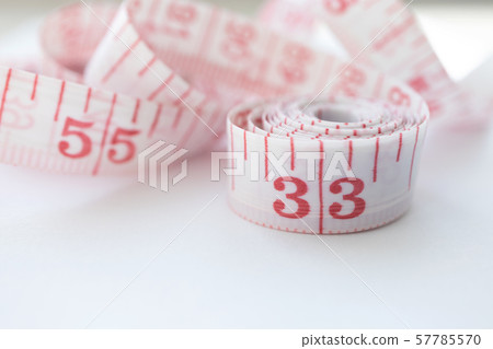 Close-up cloth tape measure with red numbers 57785570
