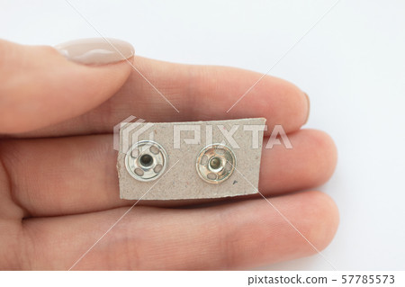 Woman hold set of metall snap fasteners, invisible Woman hold set of metall snap fasteners, invisible 57785573