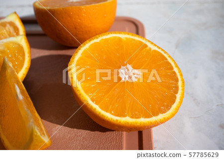 Close-up of half orange and orange slices on a Close-up of half orange and orange slices on a 57785629