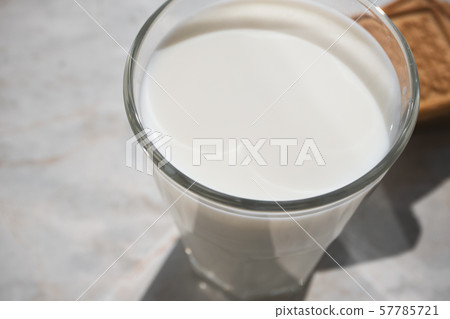 Close-up of milk surface in glass and shortbread Close-up of milk surface in glass and shortbread 57785721