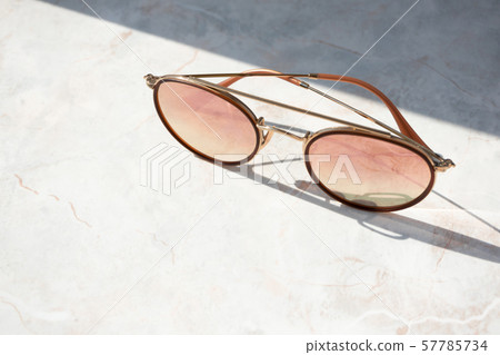 Chic female sunglasses on light marble background 57785734