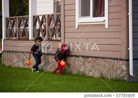 Children Playing Hide and Seek on Halloween Children Playing Hide and Seek on Halloween 57785809