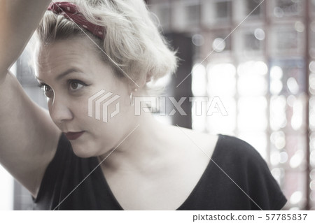 Portrait of blonde woman with short hair and pinup Portrait of blonde woman with short hair and pinup 57785837