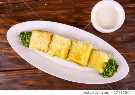 The vegetable marrows fried on oil move with sour cream 57785864