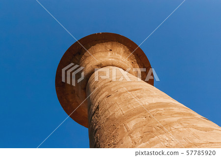 Columns in Karnak Temple Complex, famous architectural landmark in Luxor, Egypt. Pillars of the Great Hypostyle Hall from the Precinct of Amun-Re. Columns in Karnak Temple Complex, famous architectural landmark in Luxor, Egypt. Pillars of the Great Hypostyle Hall from the Precinct of Amun-Re. 57785920