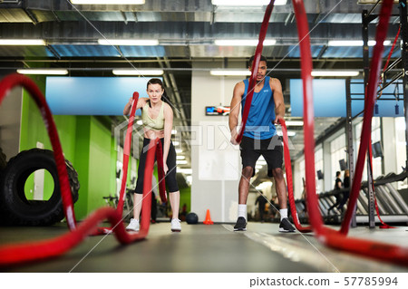 Fit Couple Working Out with Battle Ropes Fit Couple Working Out with Battle Ropes 57785994