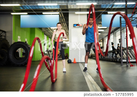 Couple Working Out with Battle Ropes Couple Working Out with Battle Ropes 57785995