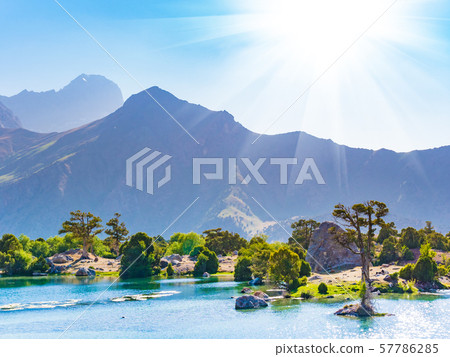 Mountain lake with blue water and a juniper tree. Fann Mountains,Tajikistan, Central Asia Mountain lake with blue water and a juniper tree. Fann Mountains,Tajikistan, Central Asia 57786285
