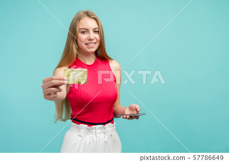 Portrait of an excited young girl showing plastic 57786649