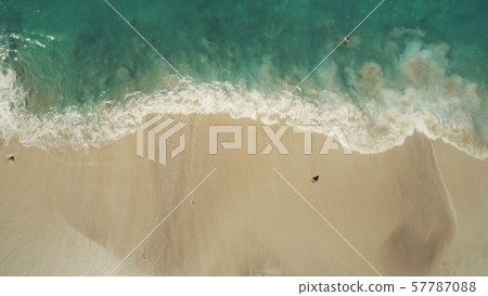 Top down view ocean beach waves break white sand 57787088