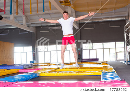 Leisure, sports games and interests - Funny young man trampolining in fly park 57788962