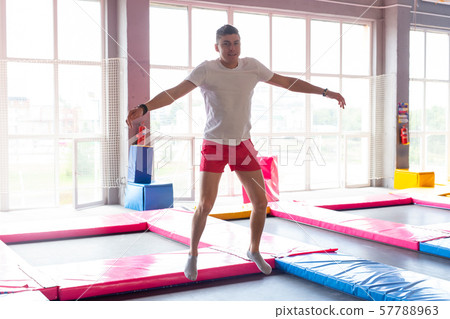 Leisure, sports games and interests - Funny young man trampolining in fly park 57788963