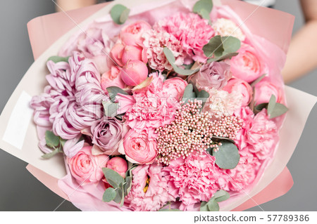 Closeup mixed flowers in bouquet. the work of the florist at a flower shop. Delicate Pastel color Closeup mixed flowers in bouquet. the work of the florist at a flower shop. Delicate Pastel color 57789386