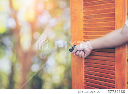 Man hand open door Handle the rocking shaft Man hand open door Handle the rocking shaft 57789388