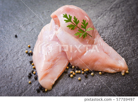 raw chicken breast with herbs and spices on black raw chicken breast with herbs and spices on black 57789497