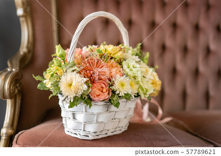 Beautiful flower composition a bouquet in a wicker basket. Floristry concept. Spring colors Beautiful flower composition a bouquet in a wicker basket. Floristry concept. Spring colors 57789621
