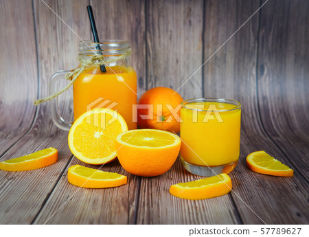 Orange juice in the glass jar and fresh orange Orange juice in the glass jar and fresh orange 57789627