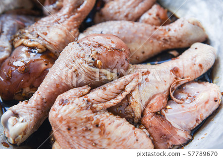 raw chicken with legs and wings with herbs and 57789670