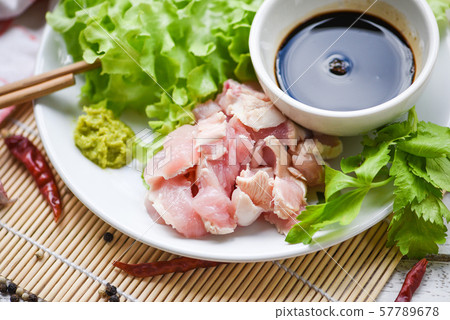 Sashimi raw chicken on white plate with wasabi Sashimi raw chicken on white plate with wasabi 57789678