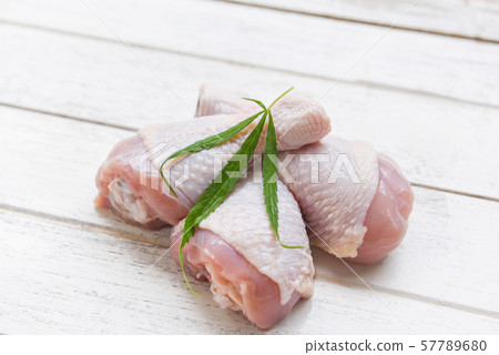 raw chicken legs with herbs marijuana leaf raw chicken legs with herbs marijuana leaf 57789680