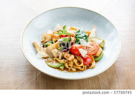 Italian pasta tagliatelle with seafood and tomato sauce. Pasta Gamberini. Parmesan cheese Italian pasta tagliatelle with seafood and tomato sauce. Pasta Gamberini. Parmesan cheese 57789745