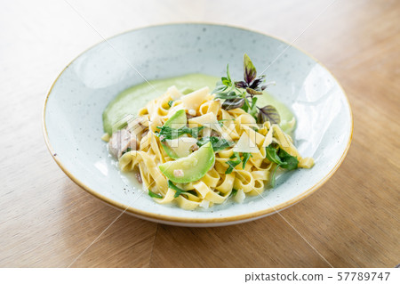 Italian pasta tagliatelle with zucchini, Turkey and green sauce. Parmesan cheese Italian pasta tagliatelle with zucchini, Turkey and green sauce. Parmesan cheese 57789747