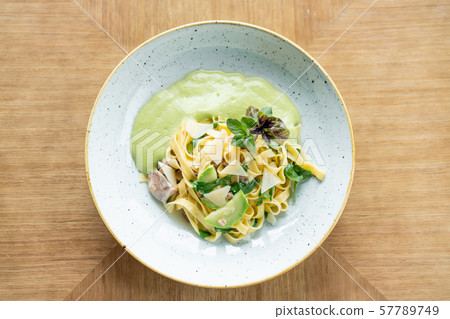 Italian pasta tagliatelle with zucchini, Turkey and green sauce. Parmesan cheese Italian pasta tagliatelle with zucchini, Turkey and green sauce. Parmesan cheese 57789749