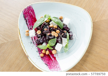 Healthy diet food. Italian salad with beetroot, basil leaves and cheese feta, with oil and small Healthy diet food. Italian salad with beetroot, basil leaves and cheese feta, with oil and small 57789750