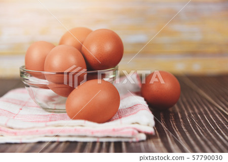 Fresh egg bowl on tablecloth on the wooden table 57790030
