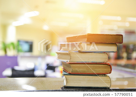 Old books on a wooden table - Open book stack in 57790051