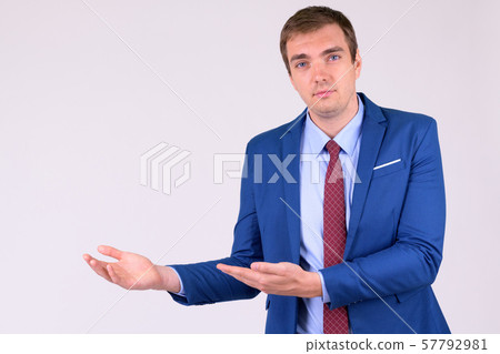 Portrait of businessman in suit showing something 57792981
