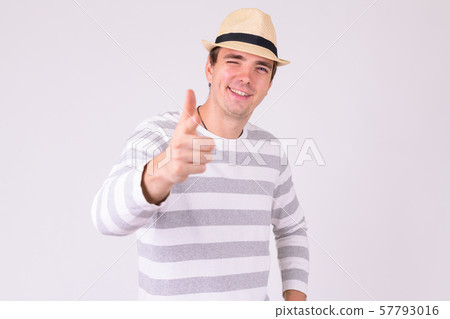 Portrait of happy tourist man winking and pointing at camera 57793016