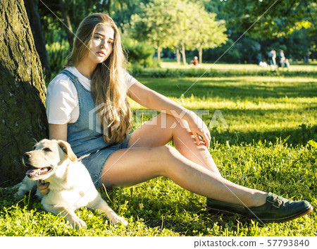 young attractive blond woman playing with her dog in green park at summer, lifestyle people concept young attractive blond woman playing with her dog in green park at summer, lifestyle people concept 57793840