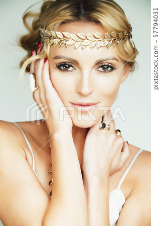 young blond woman dressed like ancient greek godess, gold jewelry and fashion makeup, people young blond woman dressed like ancient greek godess, gold jewelry and fashion makeup, people 57794031