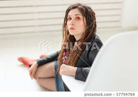 Fashion and beauty concept - young stylish woman in dreadlocks and colourful makeup 57794769