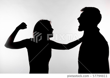 Domestic violence and abuse concept - Silhouette of a woman slapping a man Domestic violence and abuse concept - Silhouette of a woman slapping a man 57794811