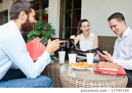 Smiling entrepreneur checking smartphone Smiling entrepreneur checking smartphone 57795140