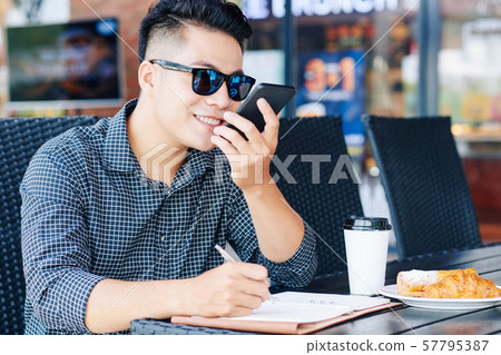 Man recording voice message Man recording voice message 57795387