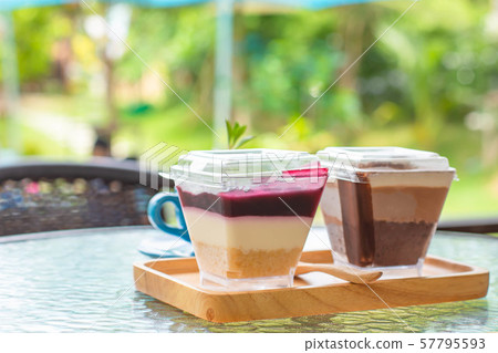Cakes and wooden trays on glass table Background tree. Cakes and wooden trays on glass table Background tree. 57795593