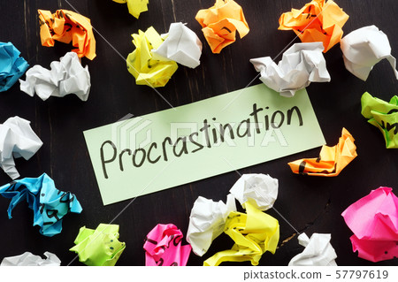 Procrastination sign and colored paper balls. Procrastination sign and colored paper balls. 57797619
