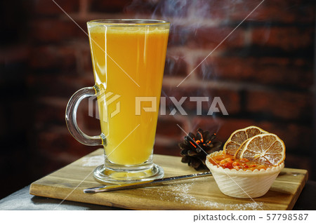 Delicious hot orange cocktail with dessert Delicious hot orange cocktail with dessert 57798587