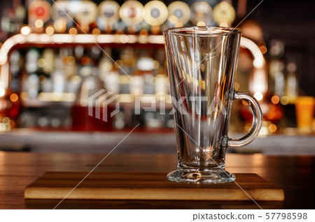 Empty mug standing on a wooden board in a pub Empty mug standing on a wooden board in a pub 57798598